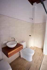 a bathroom with a toilet and a sink at Casa Manglares Capurganá in Acanti