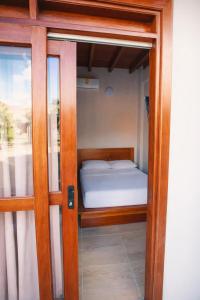 a door to a room with a bed inside at Casa Manglares Capurganá in Acanti