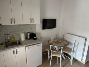 a kitchen with a sink and a table with chairs at Alexander in Ierissos