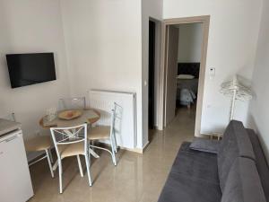 a living room with a couch and a table at Alexander in Ierissos