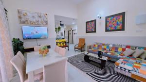 a living room with a couch and a table at Homestay DAR AL - JUFRY fully aircond in Kuantan