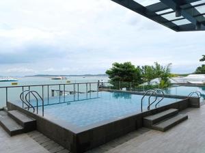 a swimming pool with a view of the water at 3 Bed Room One Residence by momo in Pulau Sembakau Kecil
