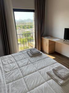 a bedroom with a bed and a large window at Clean City Agrotourism in Durrës +29 photos