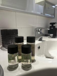 three bottles of medicine sitting on a bathroom sink at Artiste Poros House in Poros +22 photos