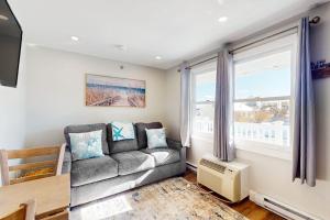 a living room with a couch and a window at Splash & Relax Unit 203 in Wells