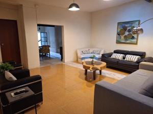 a living room with two couches and a table at Santuario del Sol in Mérida