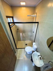 a bathroom with a toilet and a sink and a shower at Pousada Barcelos Florianópolis in Florianópolis