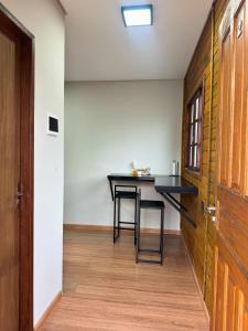 a dining room with a table and chairs and a door at Pousada Barcelos Florianópolis in Florianópolis