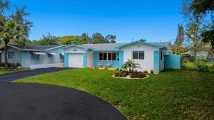 a blue house with a driveway at Ebenezer Home in Hallandale Beach