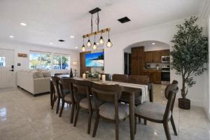 a dining room and living room with a table and chairs at Ebenezer Home in Hallandale Beach
