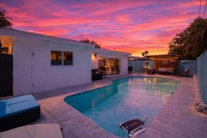 a house with a swimming pool with a sunset at Ebenezer Home in Hallandale Beach