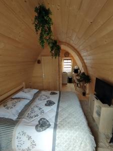 a bedroom with a bed in a log cabin at Au petit chalet in Meisenthal