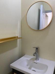 a bathroom with a white sink and a mirror at las casitas acogedora in Las Galeras