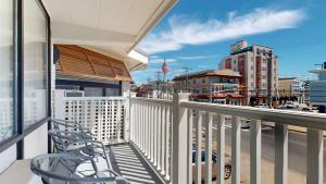 a balcony with a chair and a view of a city at The Forum in Ocean City