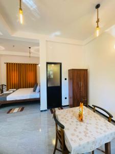 a living room with a table and a bed at Mond Villa Weligama - Private Surf & Nature Stay near Beach in Weligama