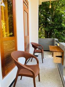 a pair of chairs and a table on a patio at Mond Villa Weligama - Private Surf & Nature Stay near Beach in Weligama