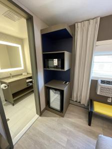 a room with a bathroom with a sink and a mirror at Le Grand Hotel St-Georges in Saint-Georges