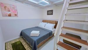 a bedroom with a bunk bed and a ladder at Homestay DAR AL - JUFRY fully aircond in Kuantan +40 photos