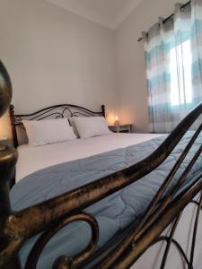 a bedroom with a bed with a wooden frame at BlueHouse III in Palekastron