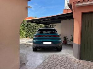 a blue pickup truck parked in a garage at VILLA EUGENIA - Luxury Flat in the Centre, with Parking Space in Bordighera