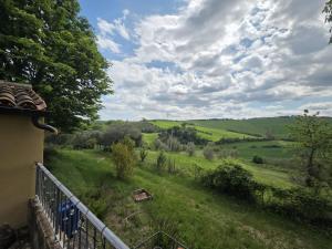a view of a green field from a house at Locazione del cavaliere in Fano