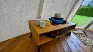 a table with two cups and a tea kettle on it at glamping podtrosky in Troskovice