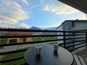a table with two cups on a balcony with a view at Lone Star Apartments in Gusinje