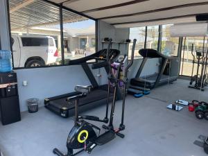 a gym with several exercise bikes and a treadmill at Executive Suites and Spa in Letlhakawe