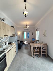 a kitchen with a table and a dining room at BlueHouse III in Palekastron