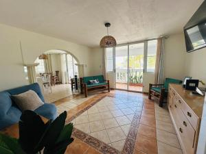 a living room with a blue couch and a table at Verano Azul Beachfront Apartment in Isabela in Isabela