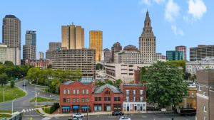 a view of a city skyline with tall buildings at Gorgeous downtown apartment with loft in Hartford