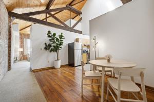 a kitchen and dining room with a table and chairs at Gorgeous downtown apartment with loft in Hartford +22 photos
