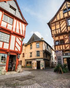 a street in a medieval town with buildings at Maison Basse in Malestroit