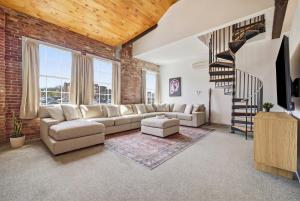 a living room with a brick wall at Gorgeous downtown apartment with loft in Hartford