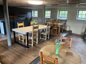 a dining room with wooden tables and chairs at Aux Sabots du Temps in Vielsalm