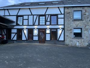 a building with a bunch of windows on it at Aux Sabots du Temps in Vielsalm