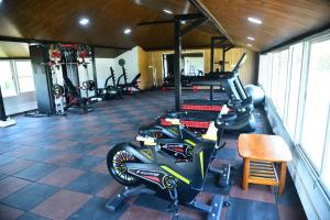 a gym with a motorcycle parked in a room at Advaya Luxury Resort, Sakleshpur in Sakleshpur