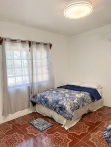 a bedroom with a bed and a window at Paradise Renewed Beach House for Deep Relaxation in El Cuyo