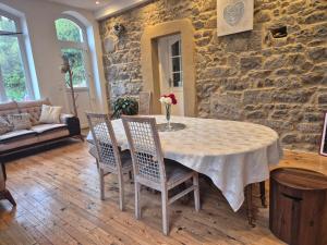 a dining room with a table and chairs at Le Berthoir in Pélussin