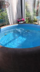 a hot tub with blue water in a room at Die Kleine Oase Erste Etage in Stuhr