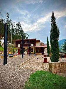 a playground in front of a house at MONTESANO Finca HOTEL in Jenesano
