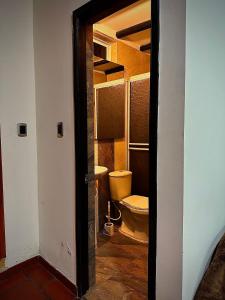 an open door to a bathroom with a toilet at MONTESANO Finca HOTEL in Jenesano