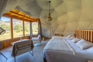 a bedroom with a large bed in a tent at Bonanza Glamp Nature Experience in El Chalten