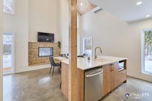 a kitchen with a sink and a counter top at Chalet Altitude Riverfront Pet-Friendly in Saint-Raymond