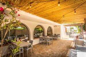a restaurant with tables and chairs and a wooden ceiling at Camping Clarà in Torredembarra