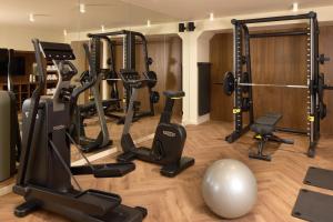 a gym with several treadmills and a ball at Hôtel d'Argenson in Paris