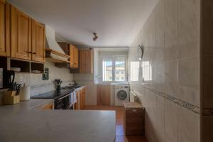 a kitchen with a washer and dryer in it at Casa Salamó in Ampuero