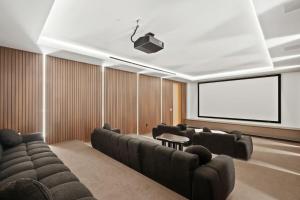 a conference room with couches and a projection screen at Stradella Como in Beverly Glen +54 photos
