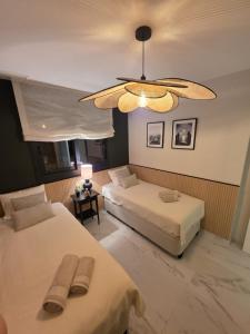 a bedroom with two beds and a ceiling fan at Flamenca Village Apartment SALSA in Orihuela Costa +78 photos