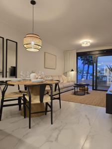 a dining room with a table and a living room at Flamenca Village Apartment SALSA in Orihuela Costa